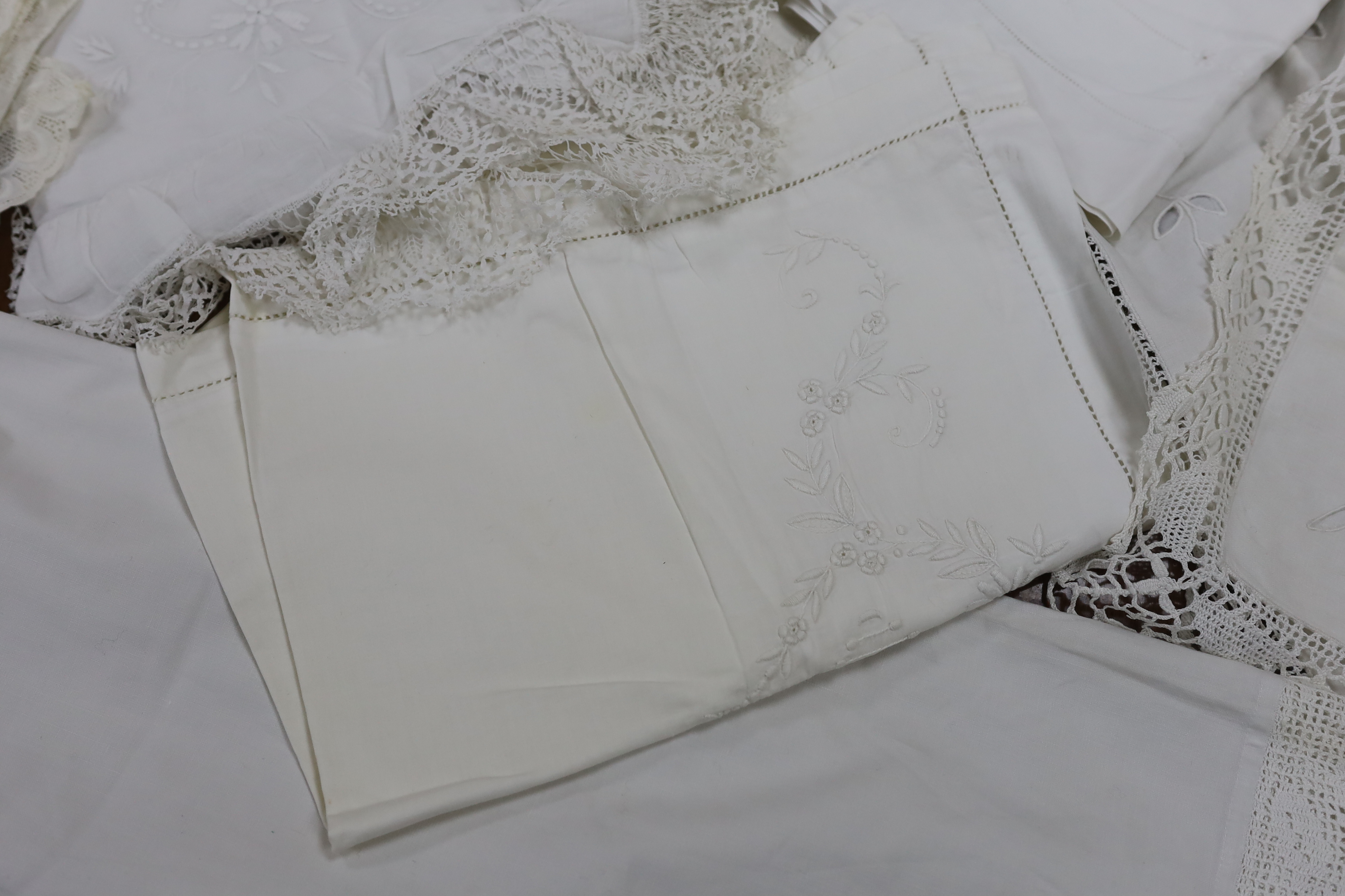 19th-20th century bed linen; a monogrammed sheet, 7ft 6in., and a smaller crochet edged sheet, a pair of French square Anglaise pillow cases, three similar appliqué pillow cases, a frilled single square pillow case and a